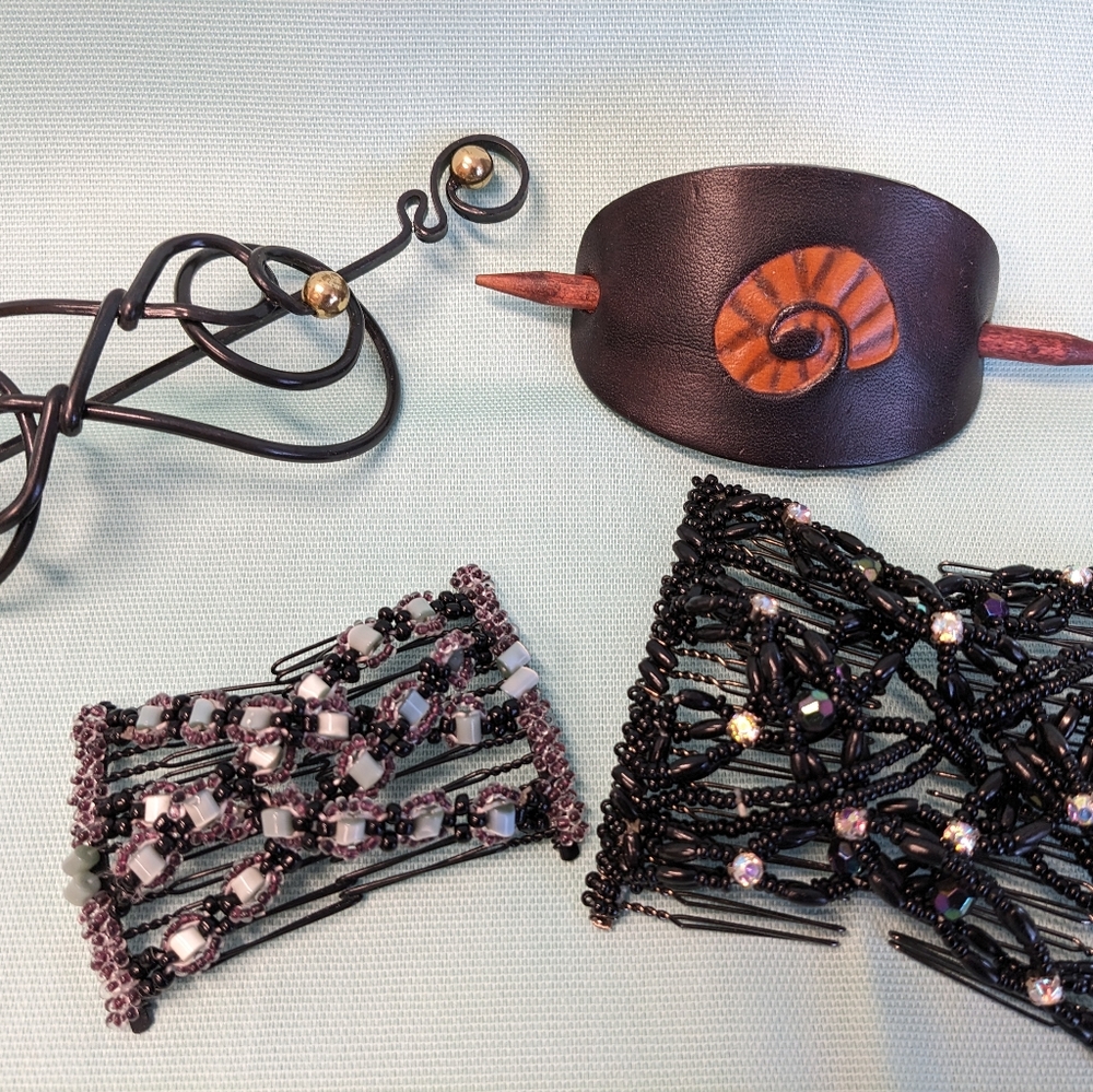 Assorted hair accessories for long hair. Two beaded combs and two pick styles.